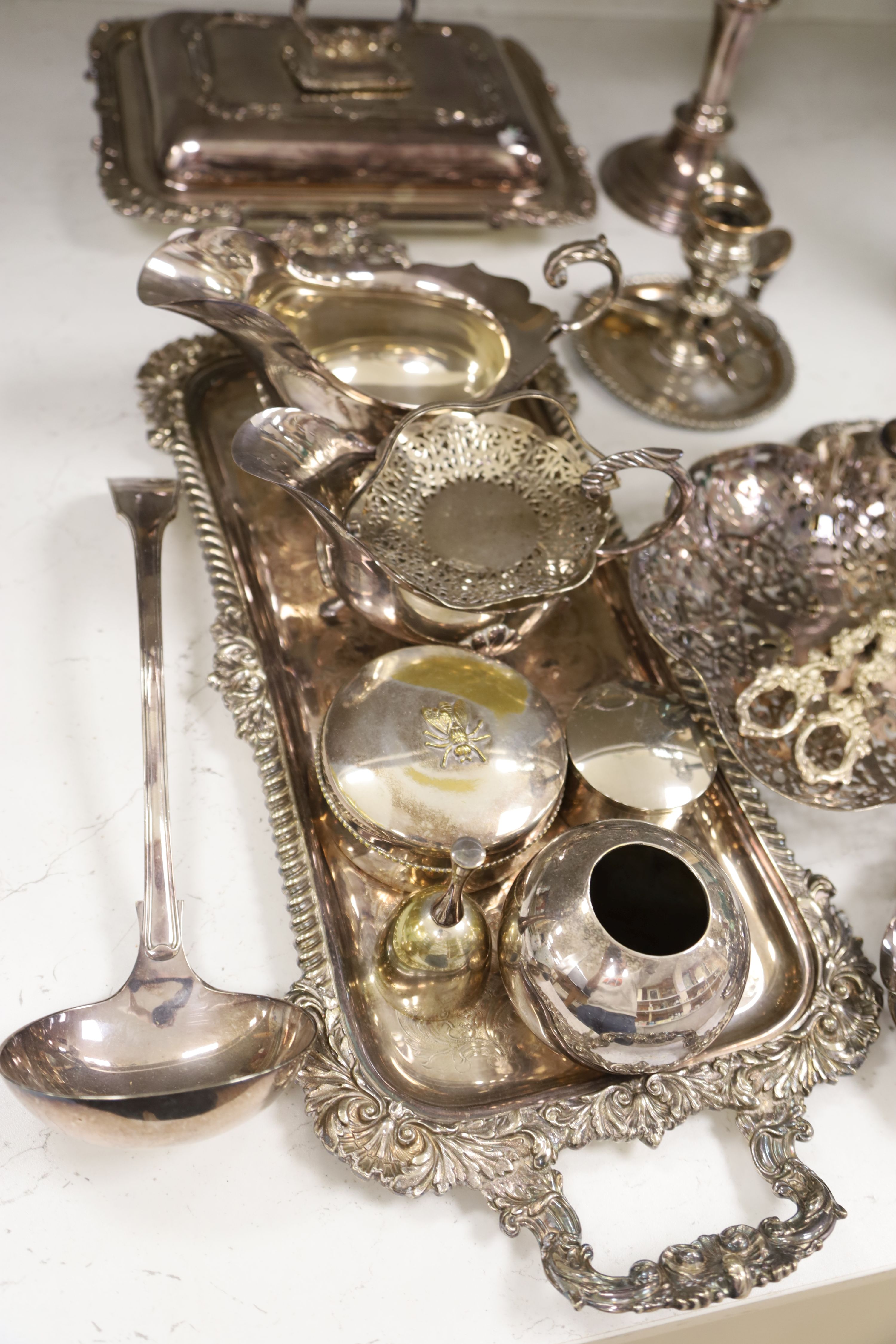 Plated wares to include an entree dish and cover, a pair of sauceboats, a pair of candlesticks and a tray